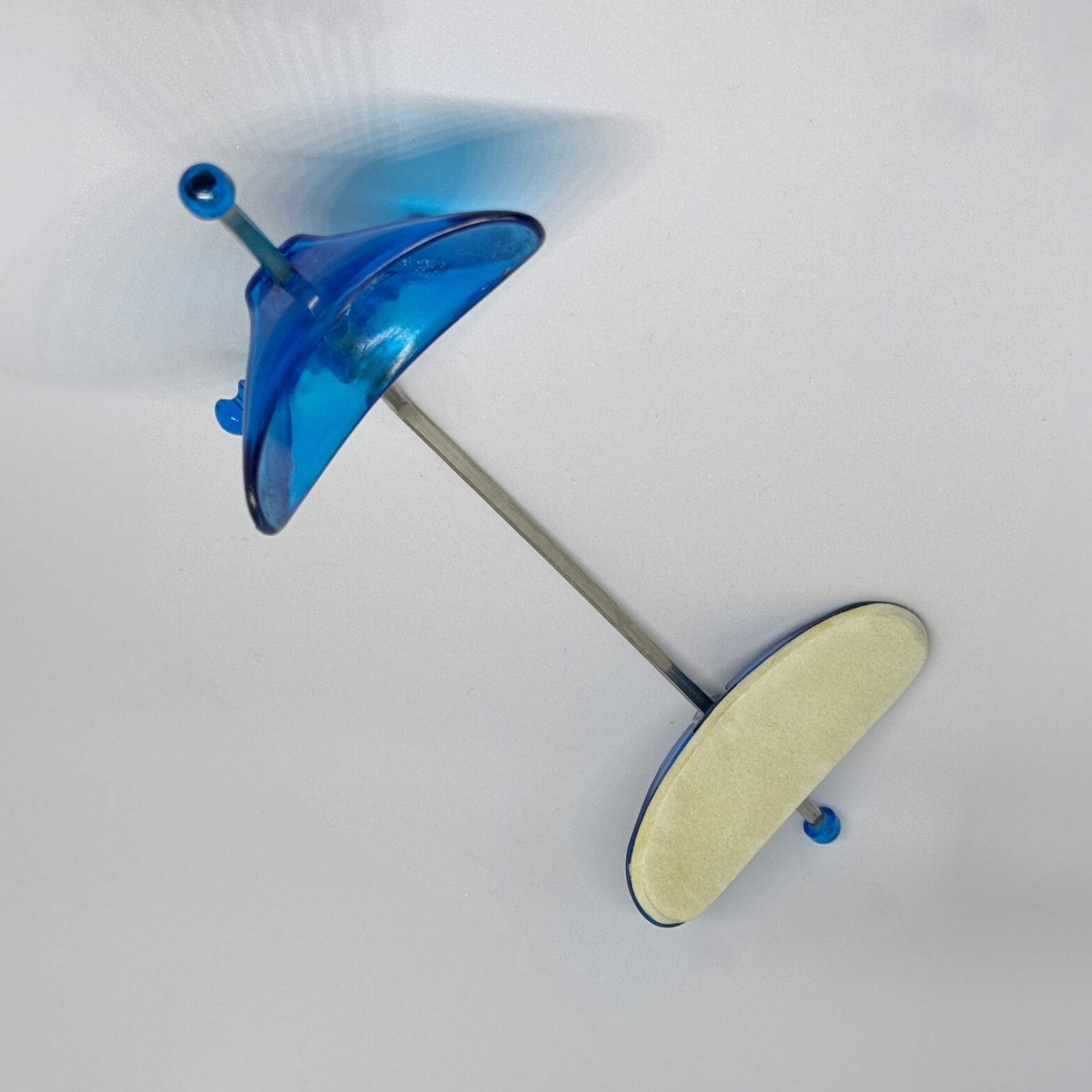 Reverse Pull Headgear appliance with blue plastic components and metal rod, designed to correct underbites and improve facial harmony in orthodontic treatment.