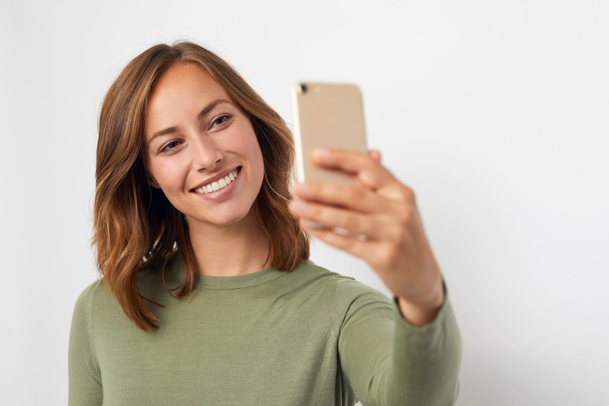 young smiling woman taking a selfie grosse pointe farms orthodontics