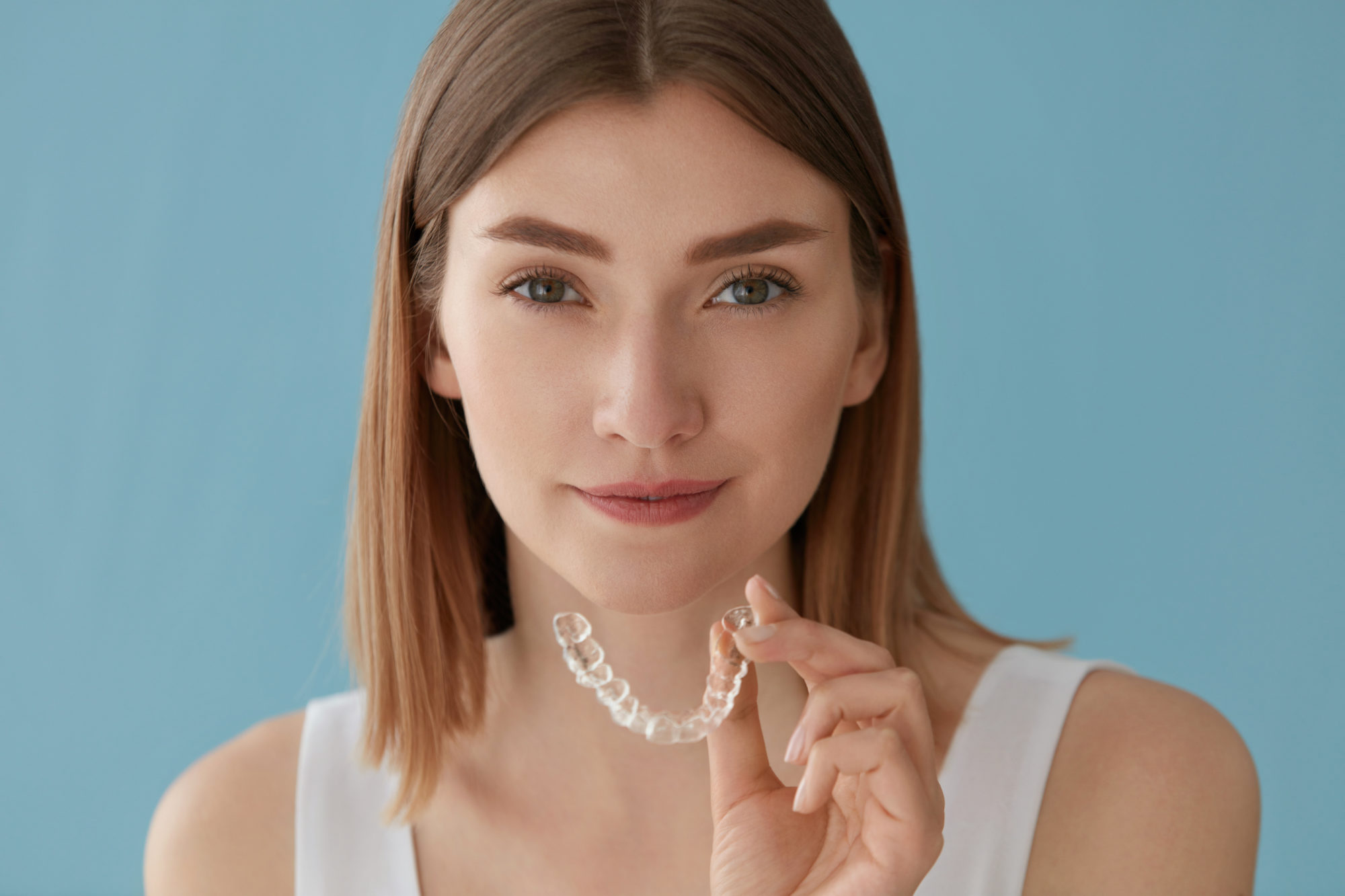Teeth whitening. Woman with healthy teeth using removable braces grosse pointe farms braces